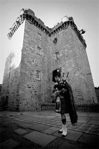 Lone piper at Lennox Town Castle